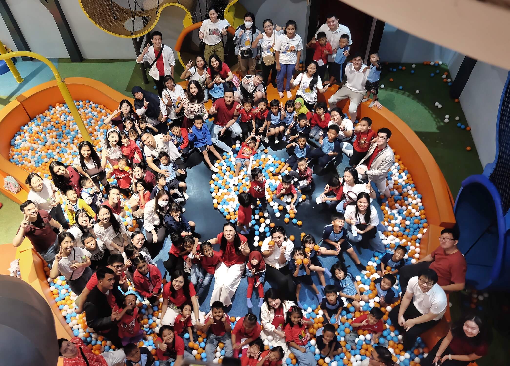 Aerial view of students and volunteers at the playground