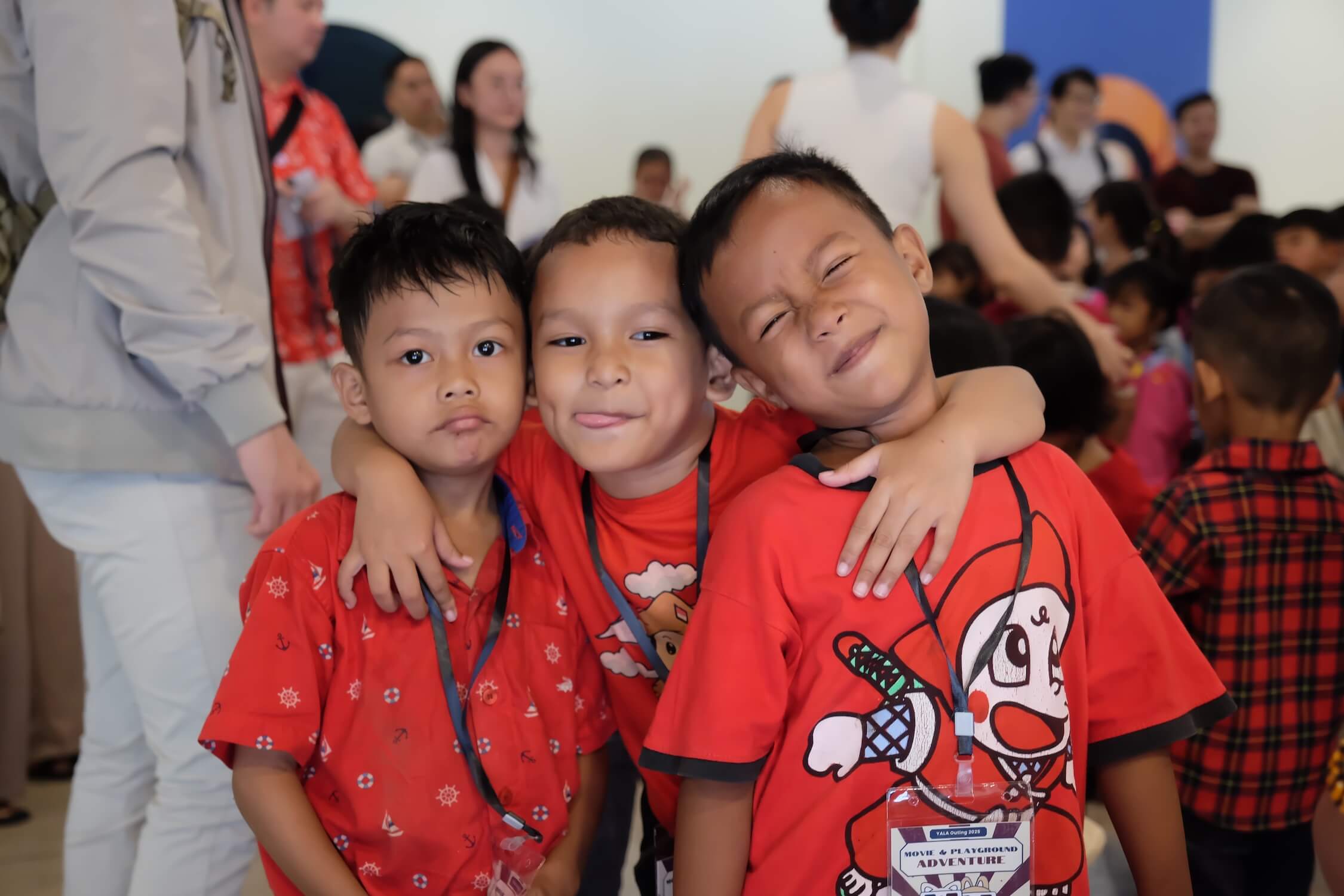 Three boys embracing at the school outing